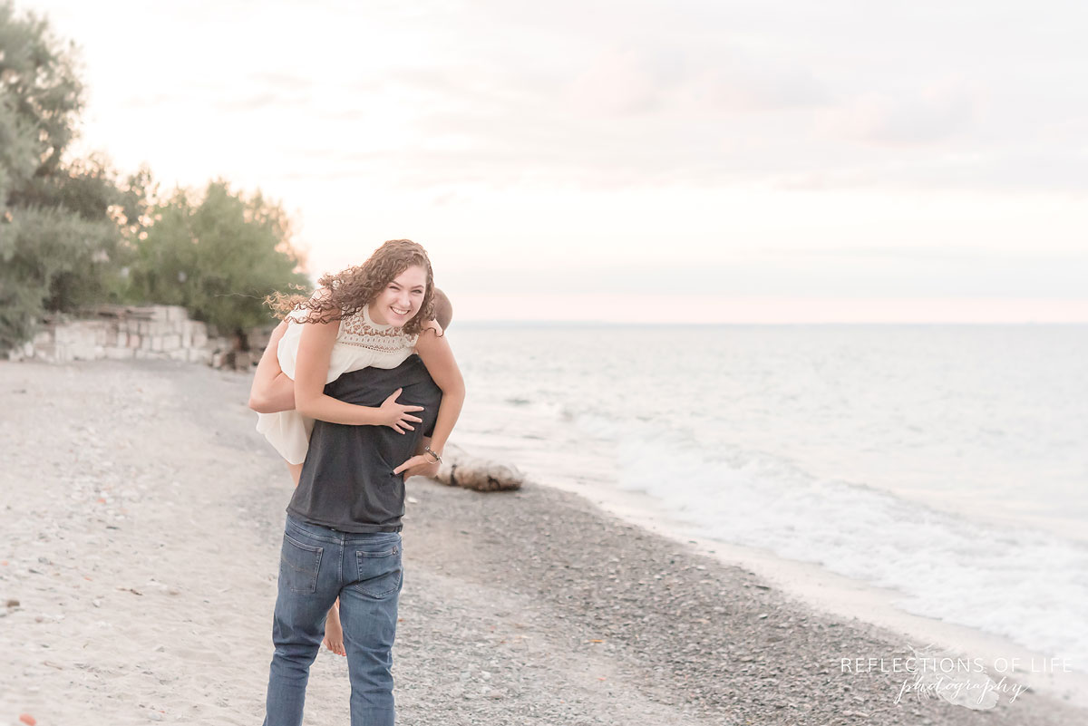 Boyfriend carrying girlfriend along the beach