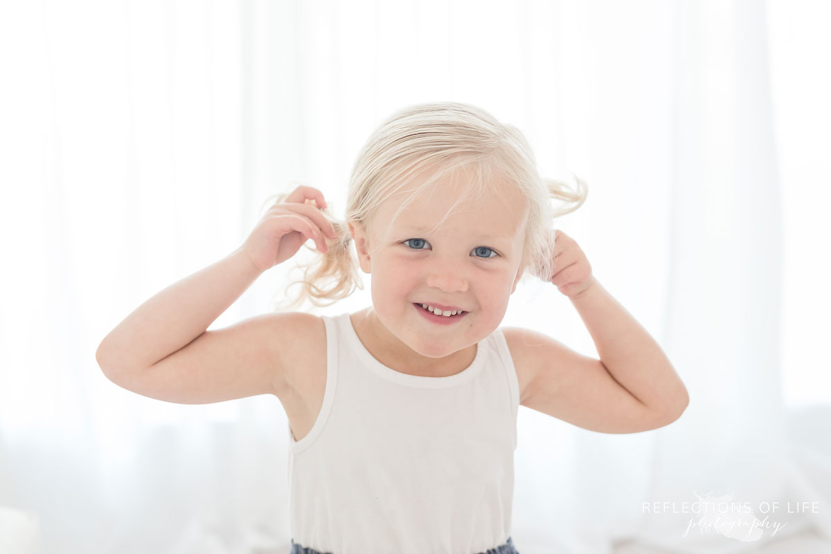 Young girl in white studio