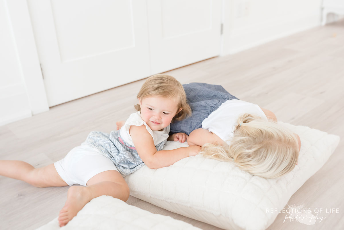 sisters playing in white studio