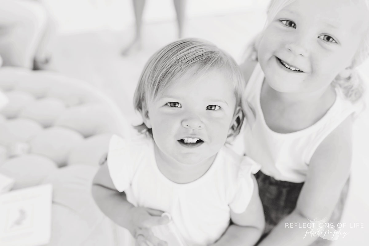 black and white of sister looking into camera