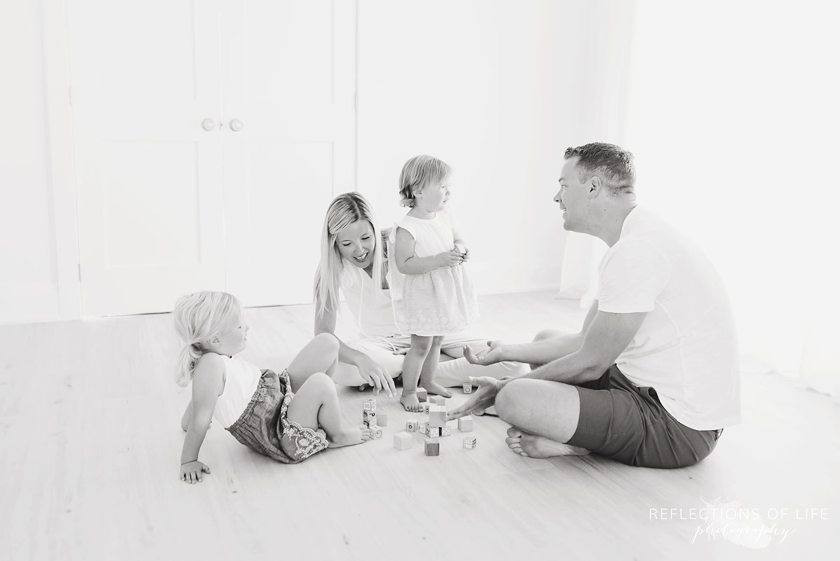 black and white of family in white studio