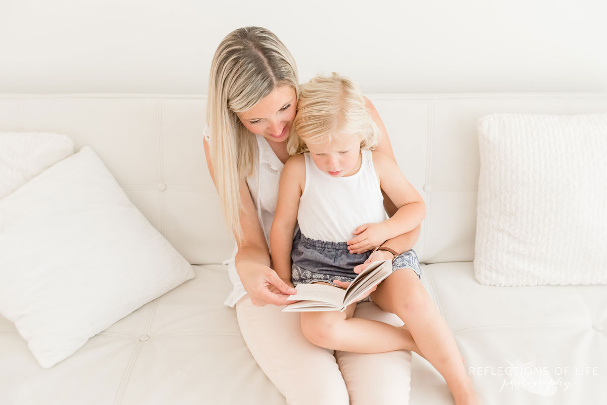 mom and daughter reading book