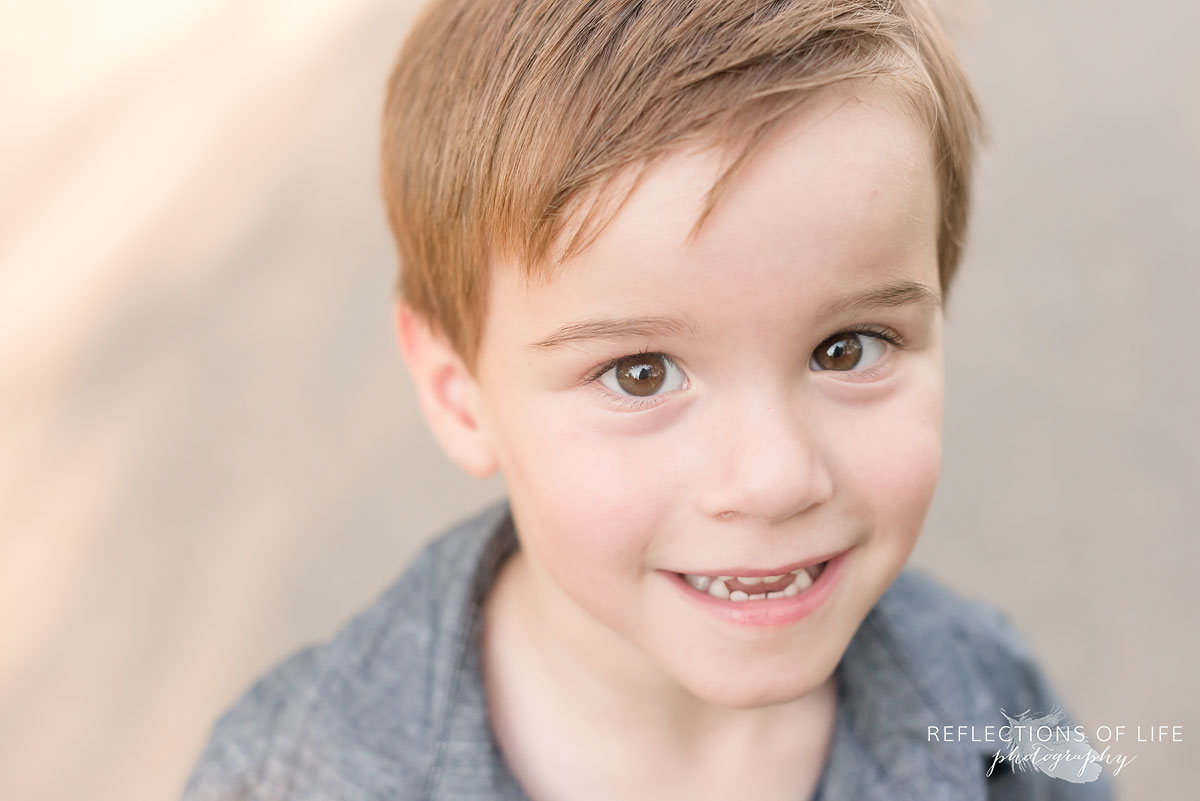Young boy smiling Reflections of Life Photography