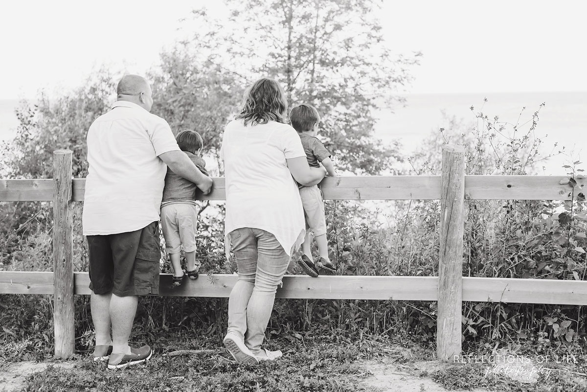 Family of four looking out at lake in Grimsby Ontario black and white