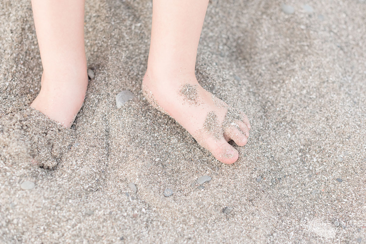 A child's toes in the sand