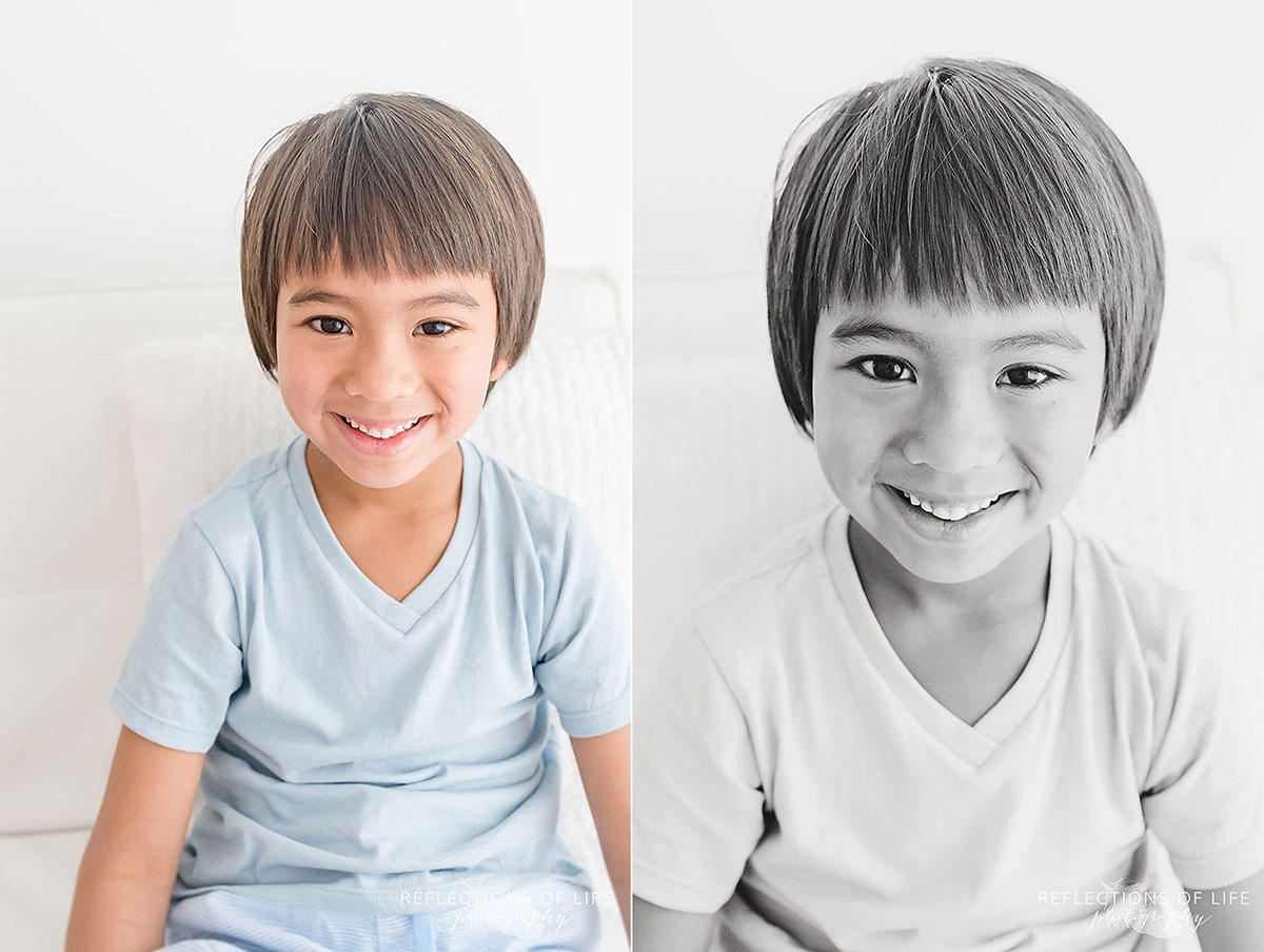 boy sitting and smiling colour black and white