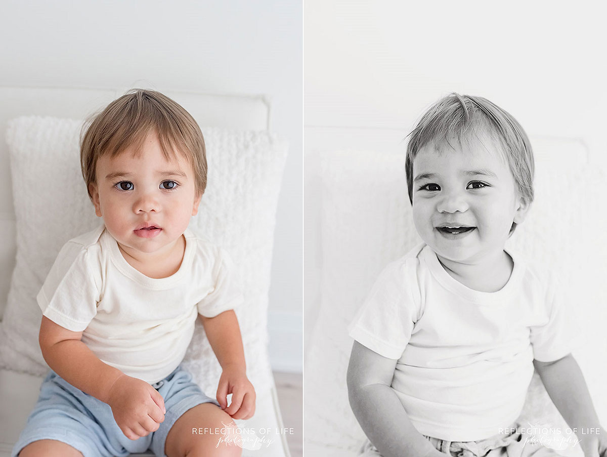 little boy sitting smiling and laughing colour black and white.jpg