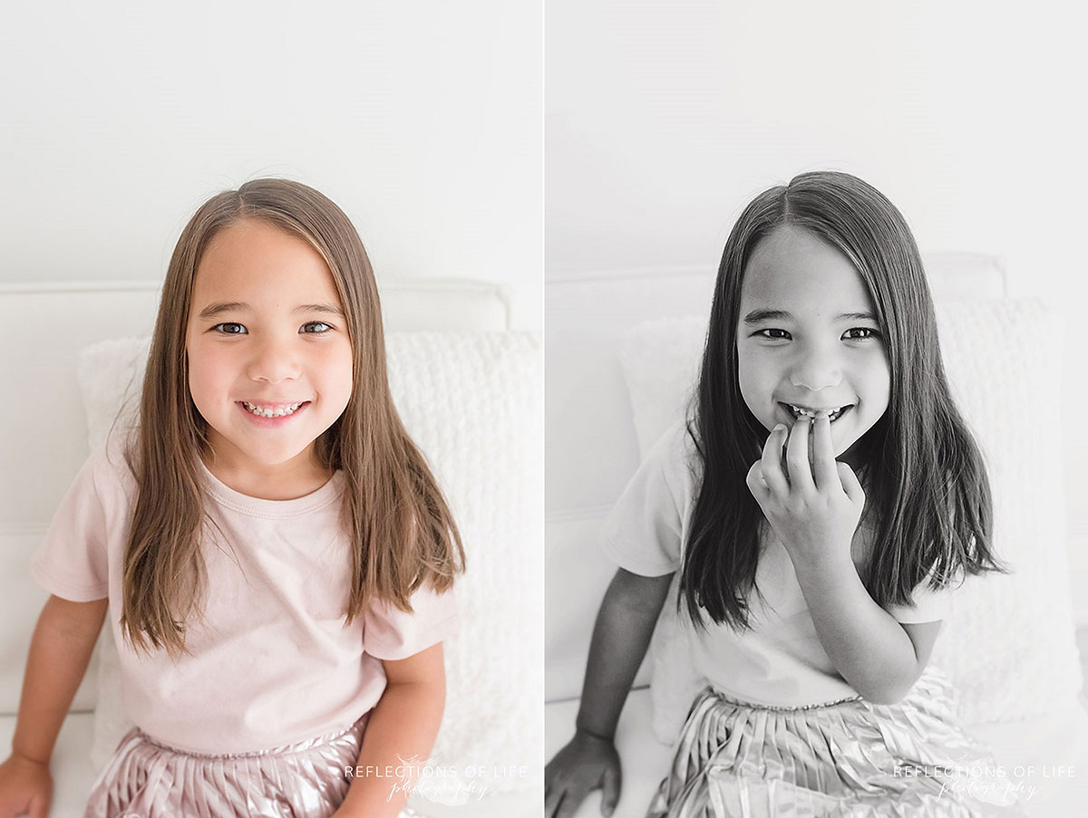 little girl sitting and smiling colour black and white