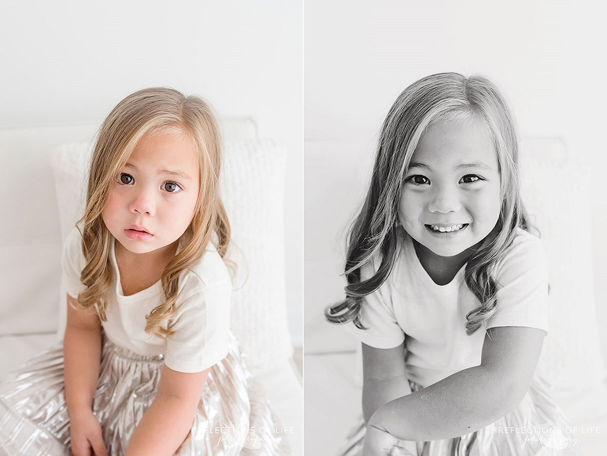 little girl sitting serious and smiling colour black and white