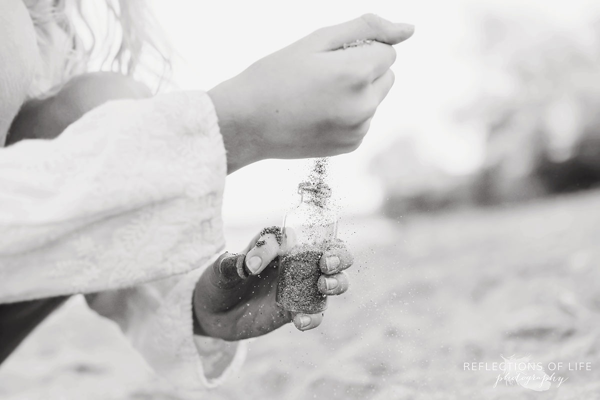 pouring sand into jar