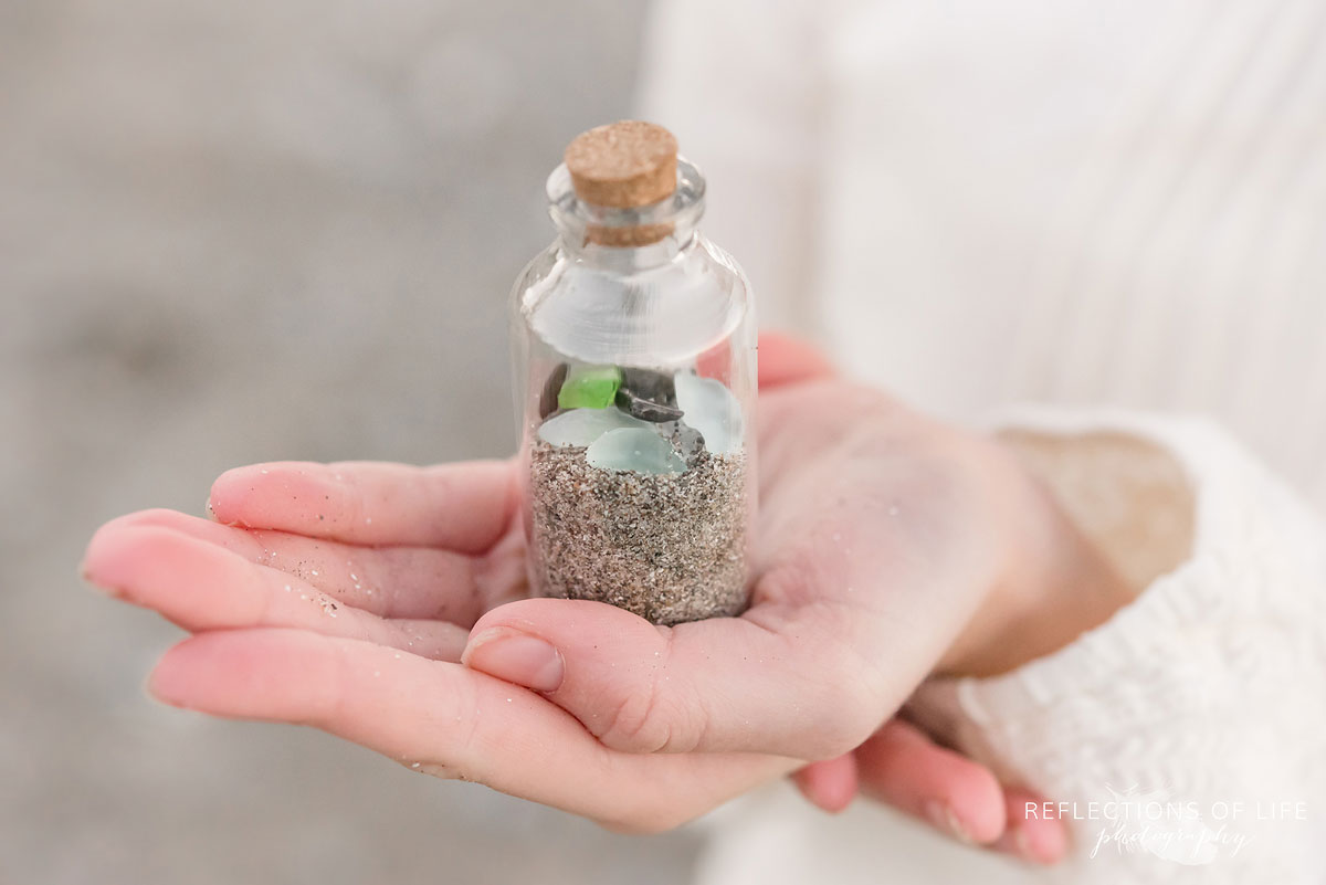jar with beach sand and glass