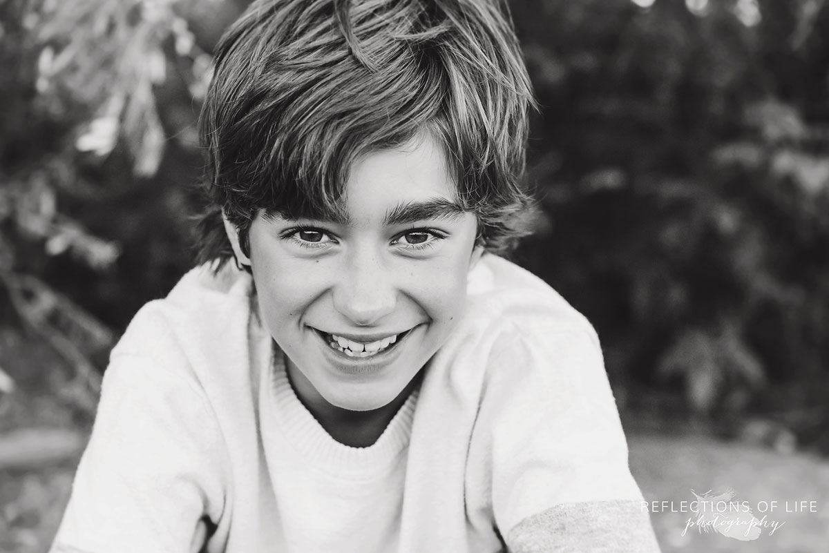 young boy smiling at family photographer Karen Byker