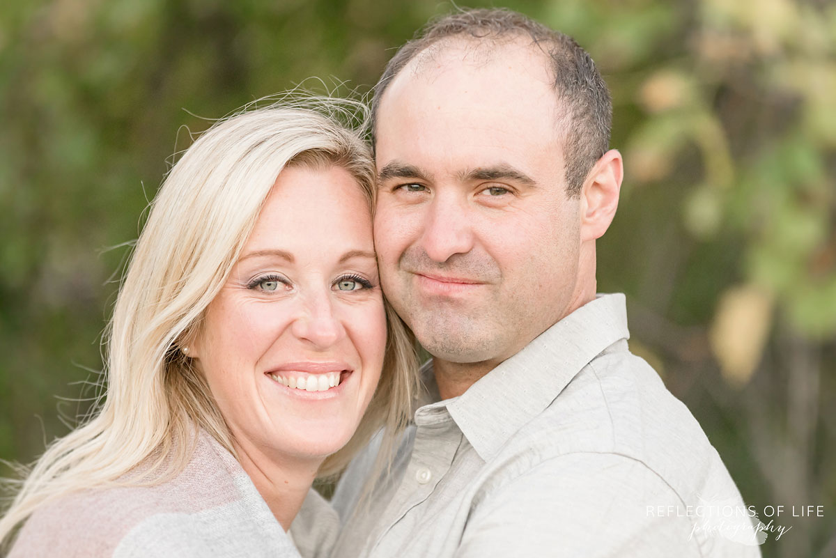 husband and wife smiling at camera