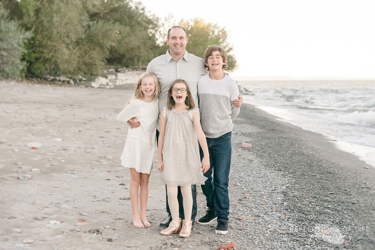 father and children on beach in Niagara Region