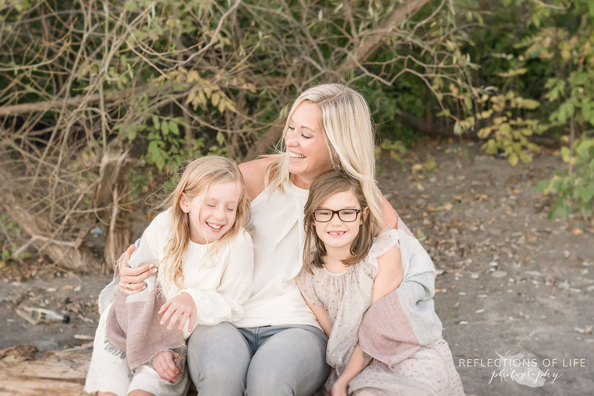 mother and daughters laughing together