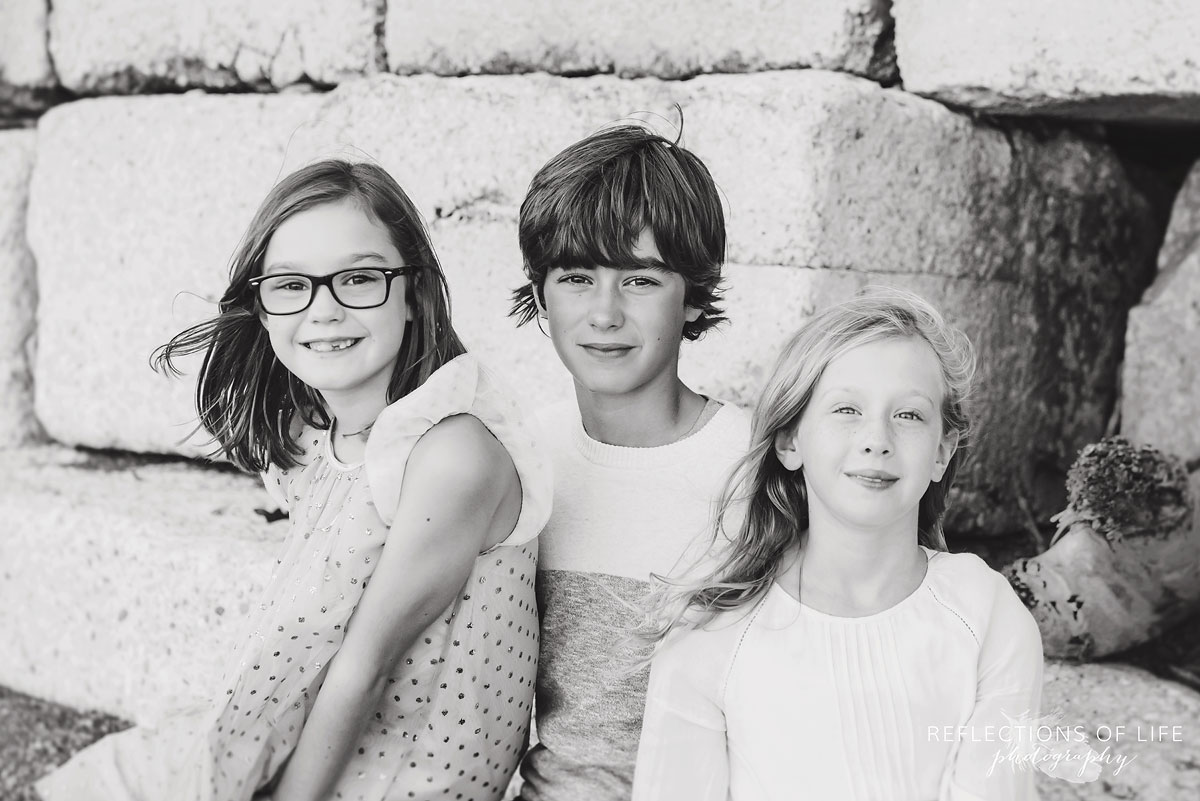 black and white of brother and two sisters