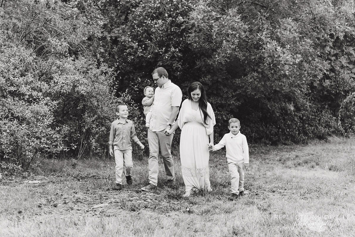 007 family walking in field black and white