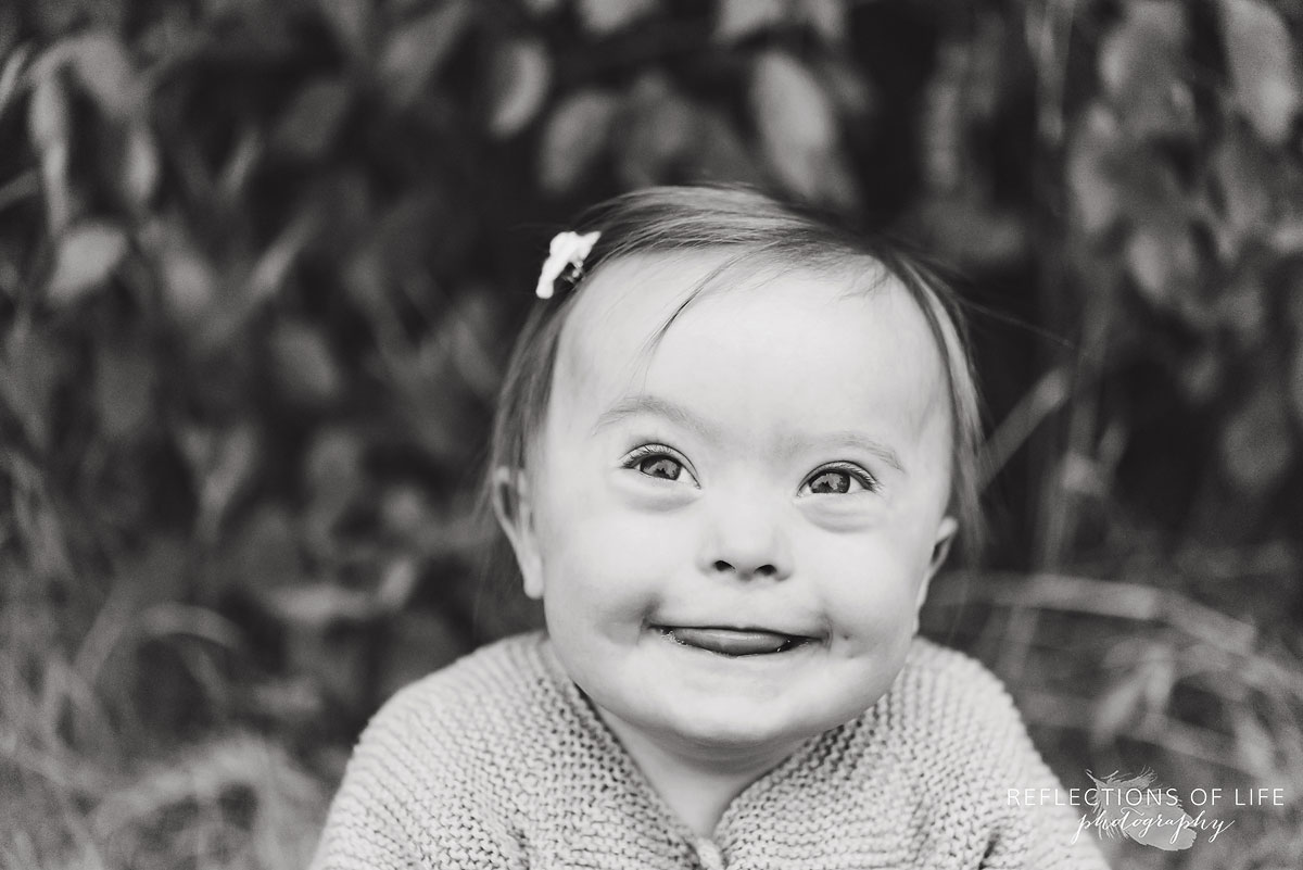 013 black and white of girl smiling at newborn photographer Karen Byker