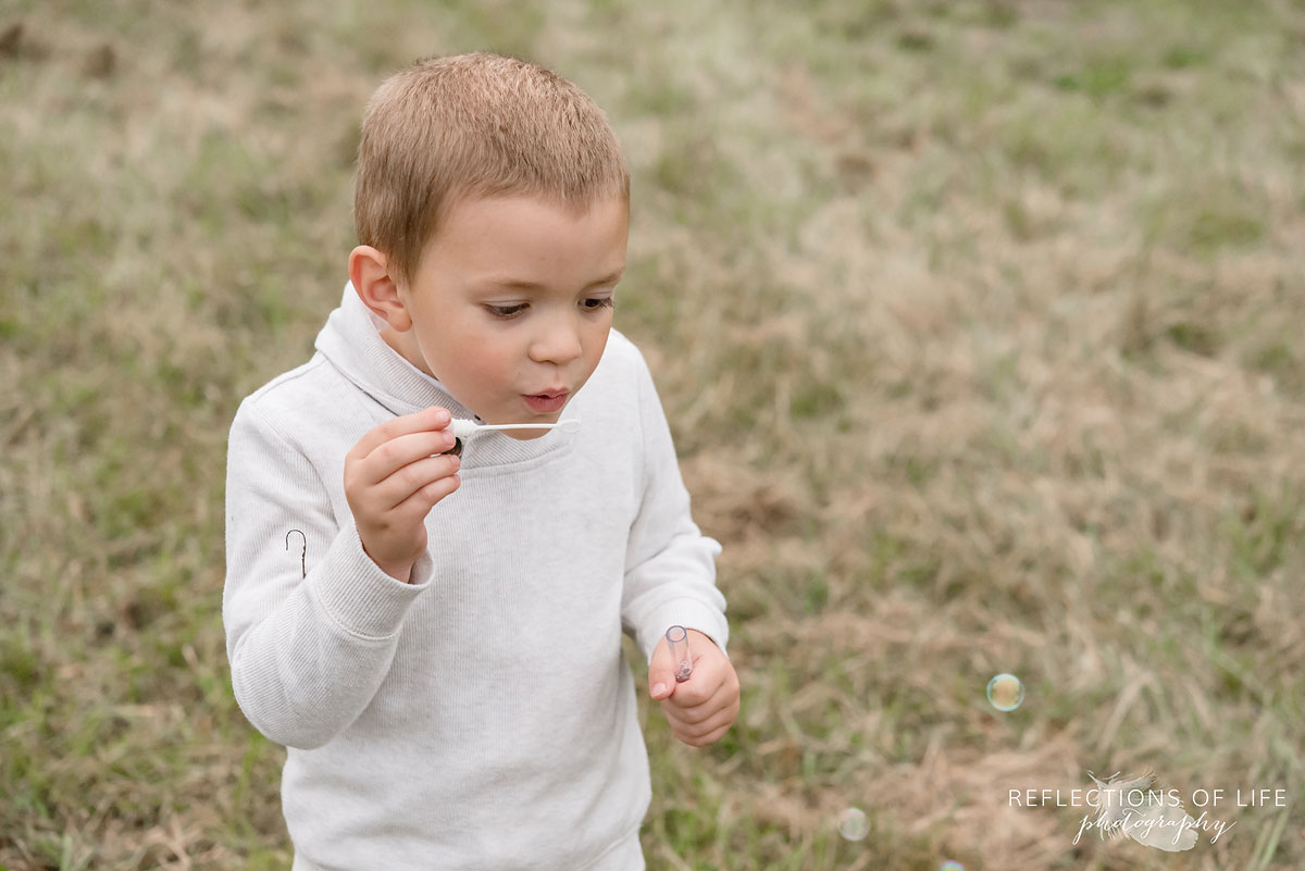 025 little boy blowing bubbles in Grimsby Ontario