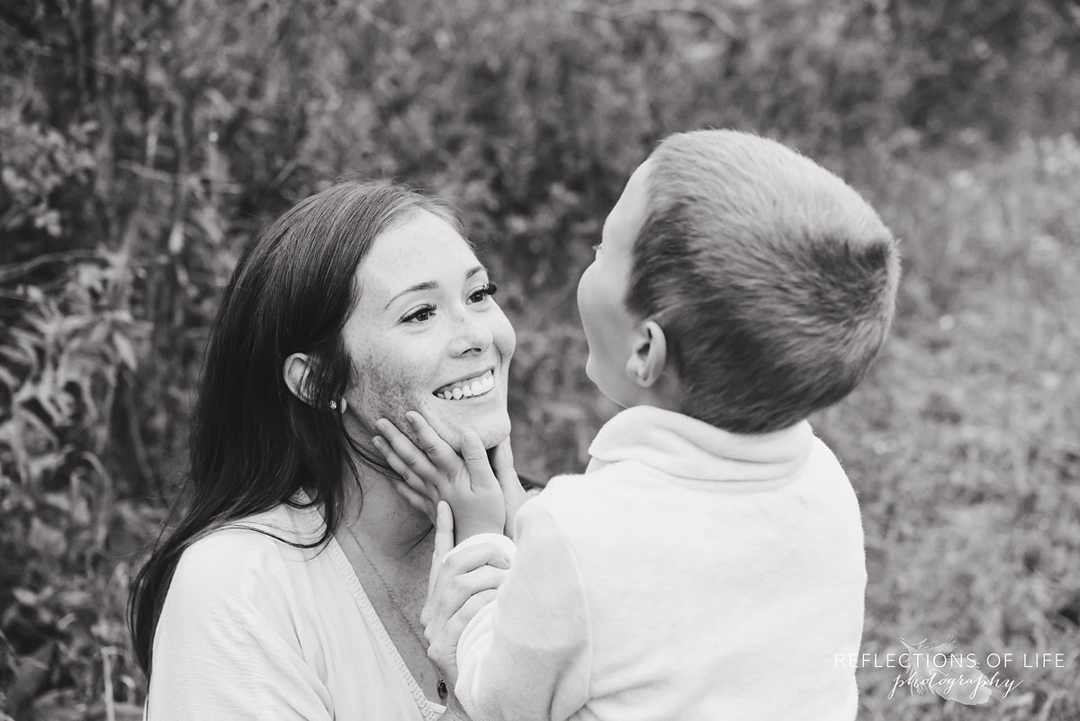 033 son holding mamas face black and white