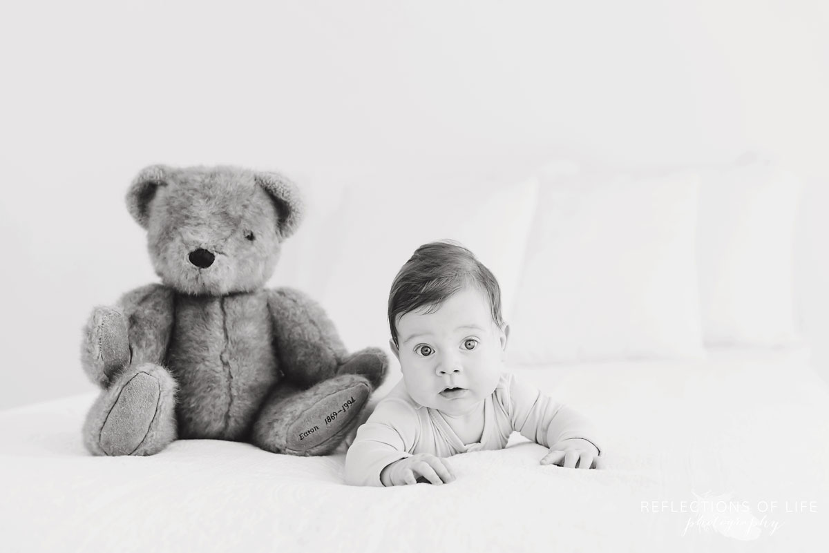 baby and teddy bear in studio