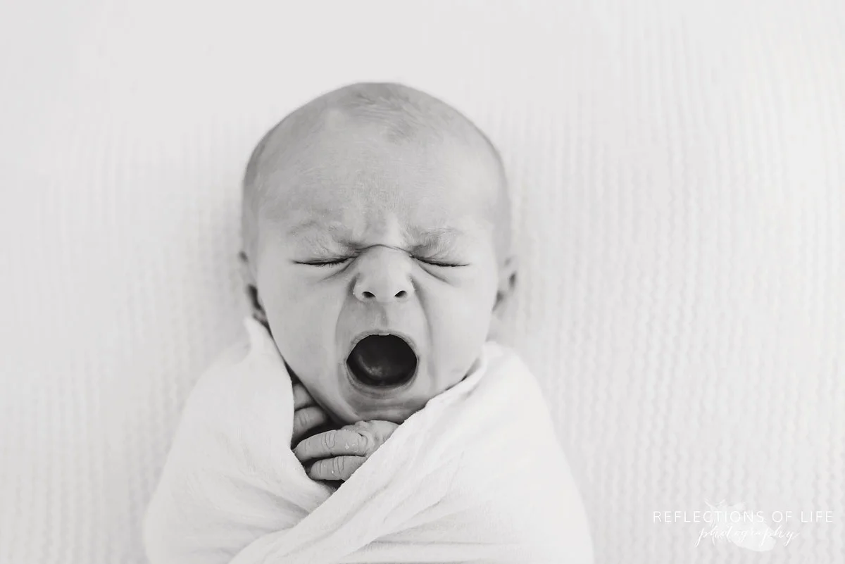 baby yawning in black and white