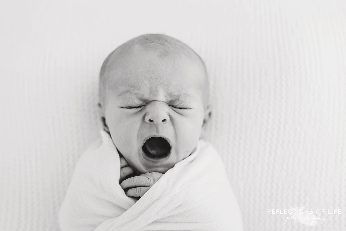 baby yawning in black and white