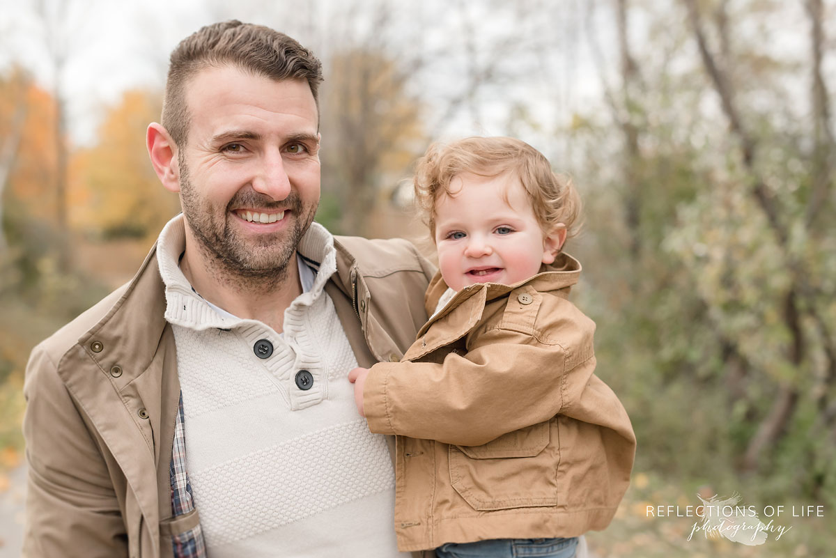 father and child smiling at camera