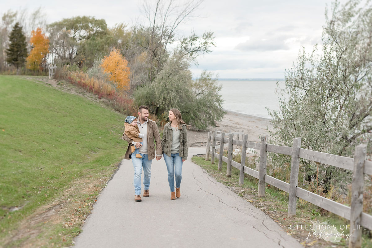 family walking on path near the beach