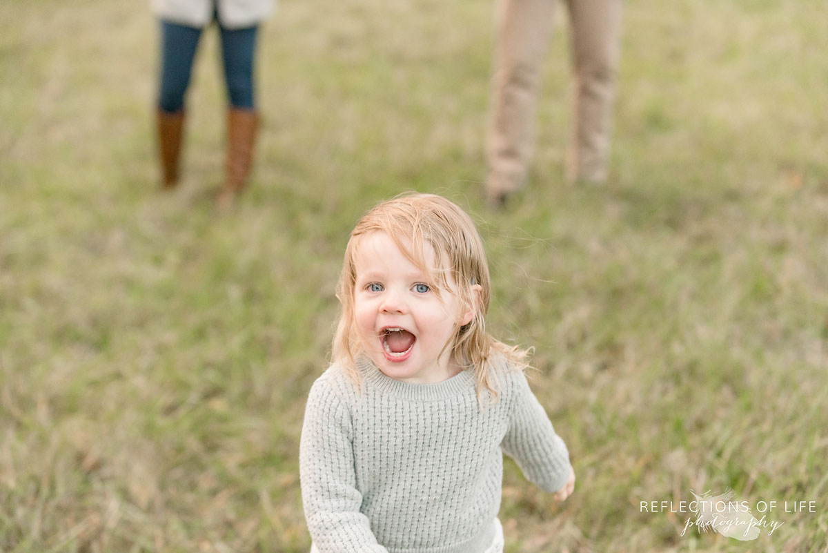 little girl running towards photographer karen byker