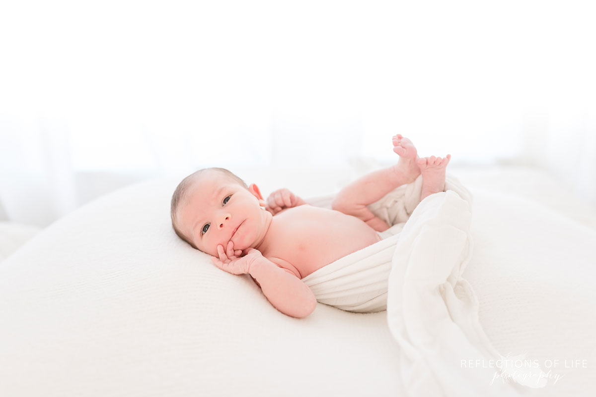 newborn on white blankets