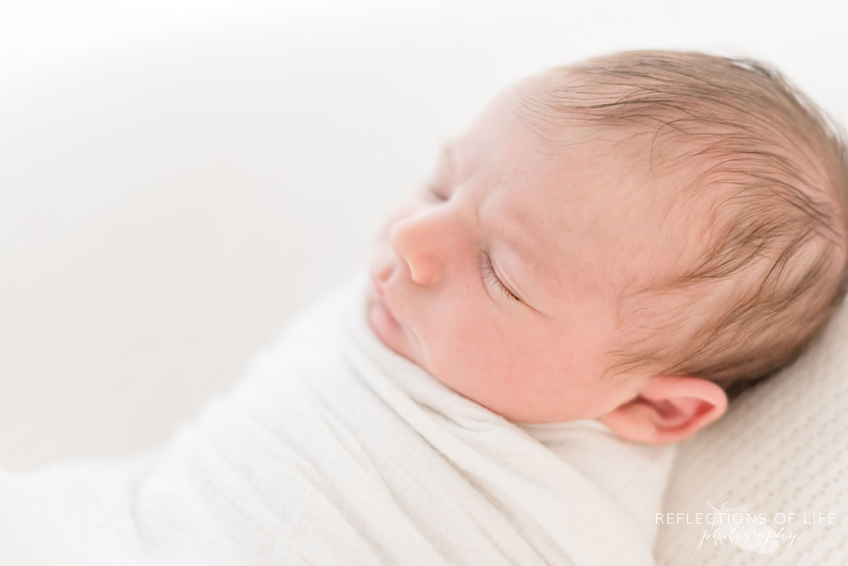 newborn sleeping in white studio grimsby