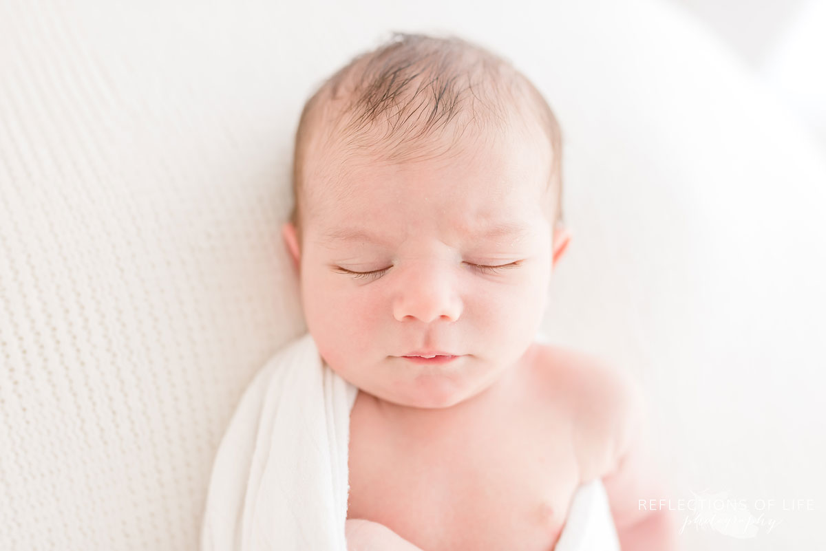 newborn sleeping in white studio grimsby ontario
