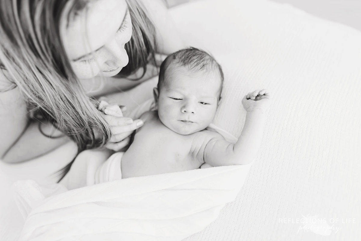 mother watching newborn 