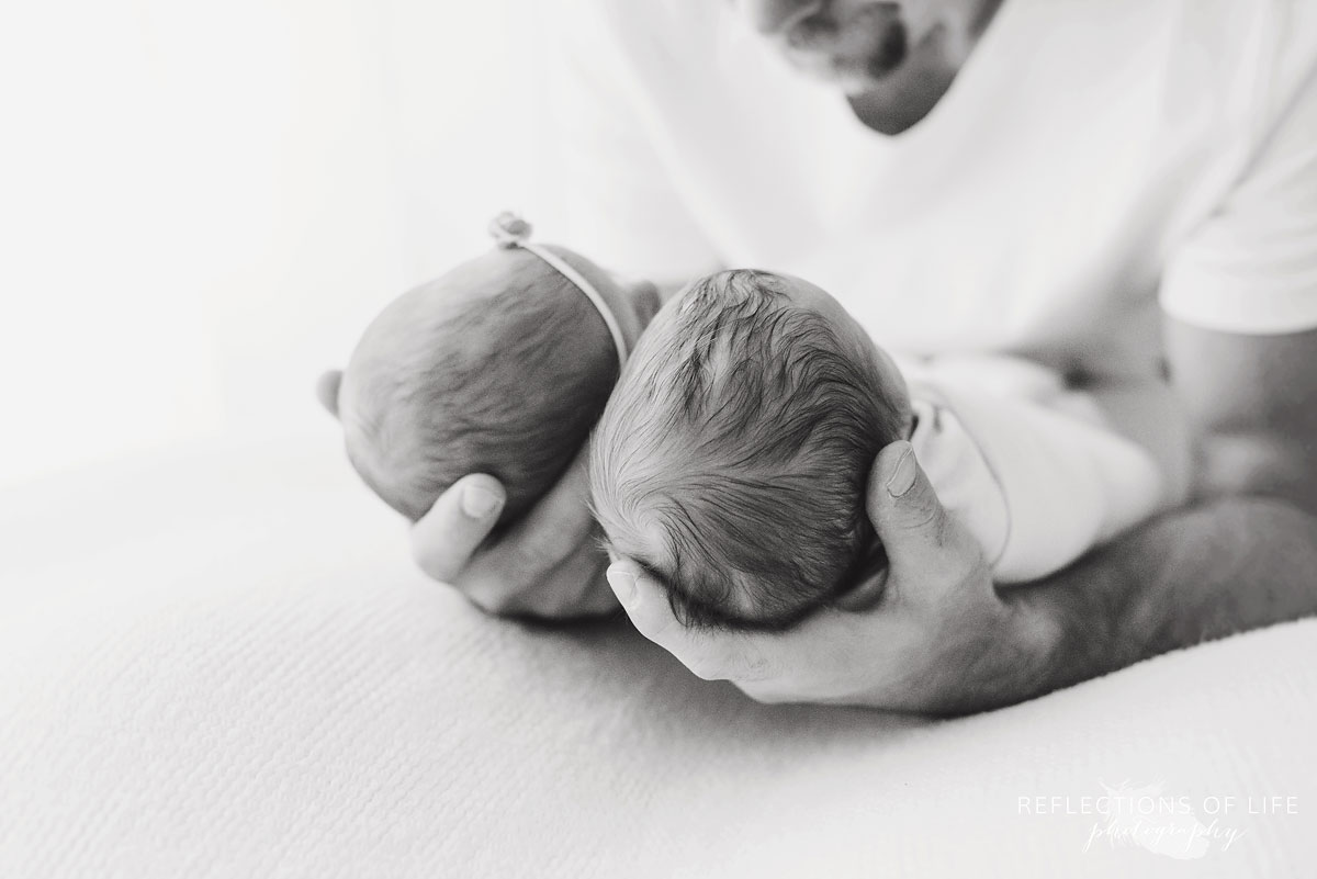 black and white of dad holding children