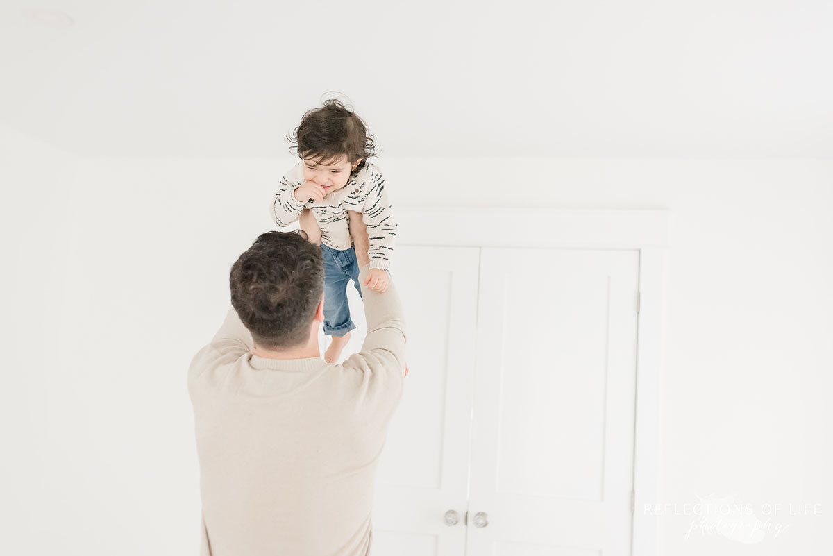father holding son