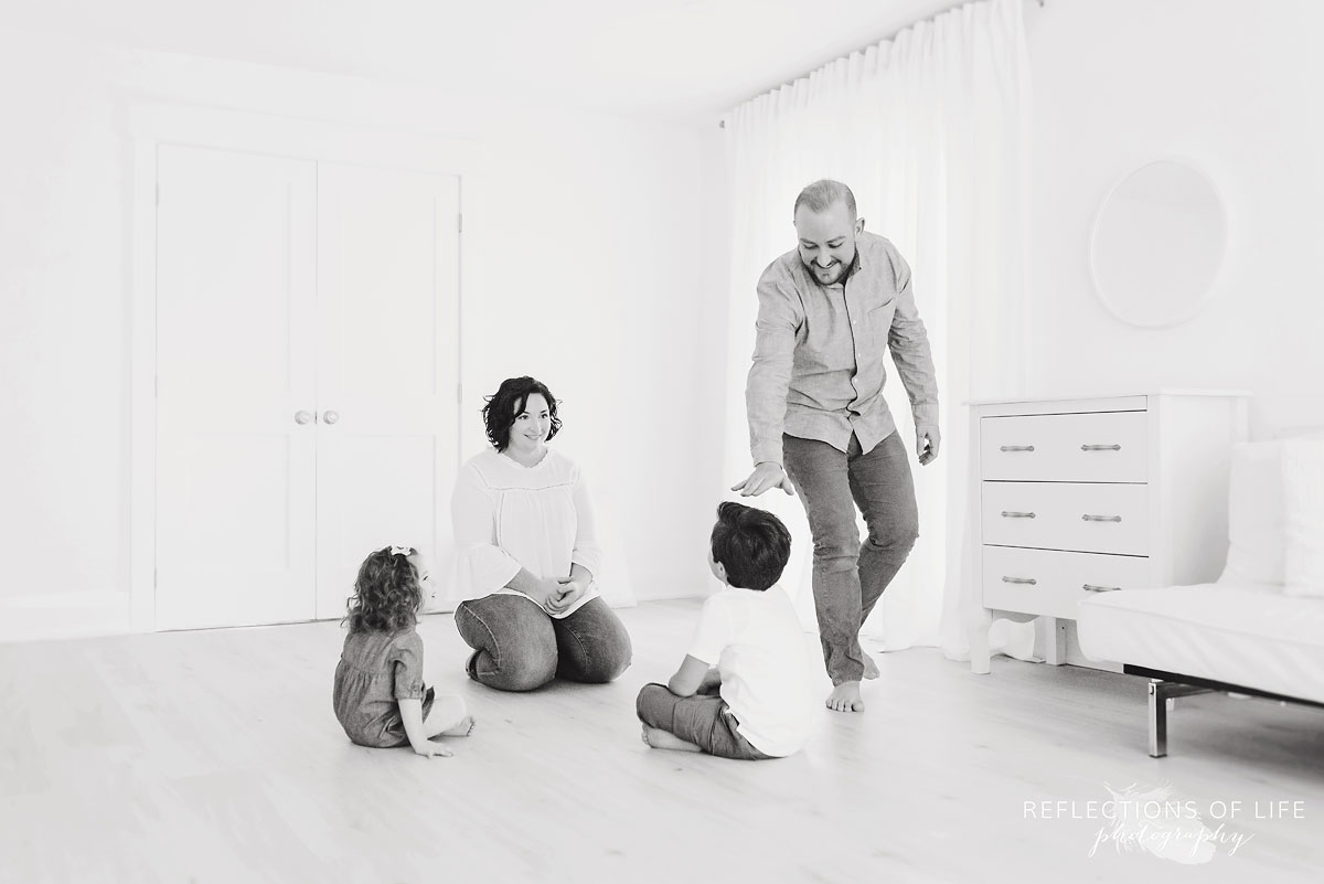 family playing a game in white studio