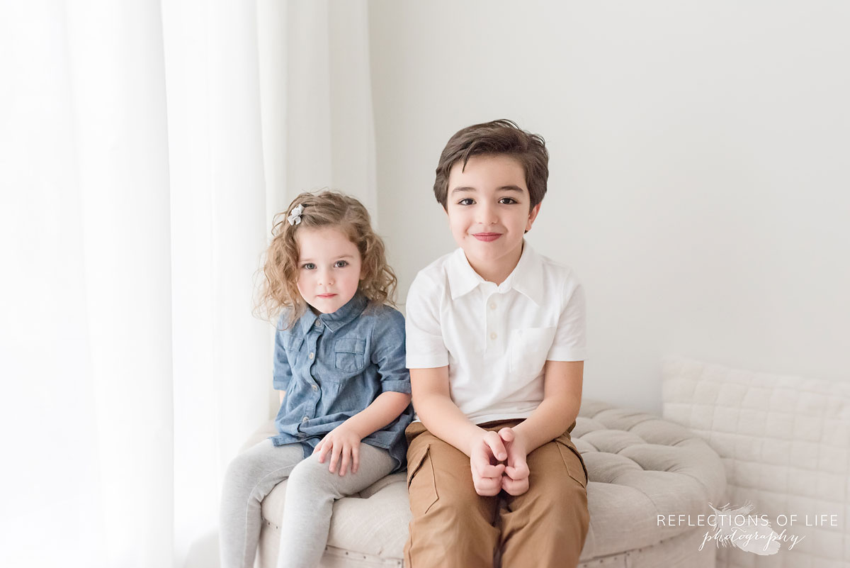 siblings in white studio