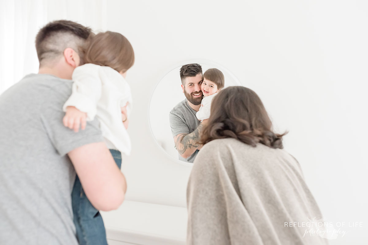 Family looking in mirror