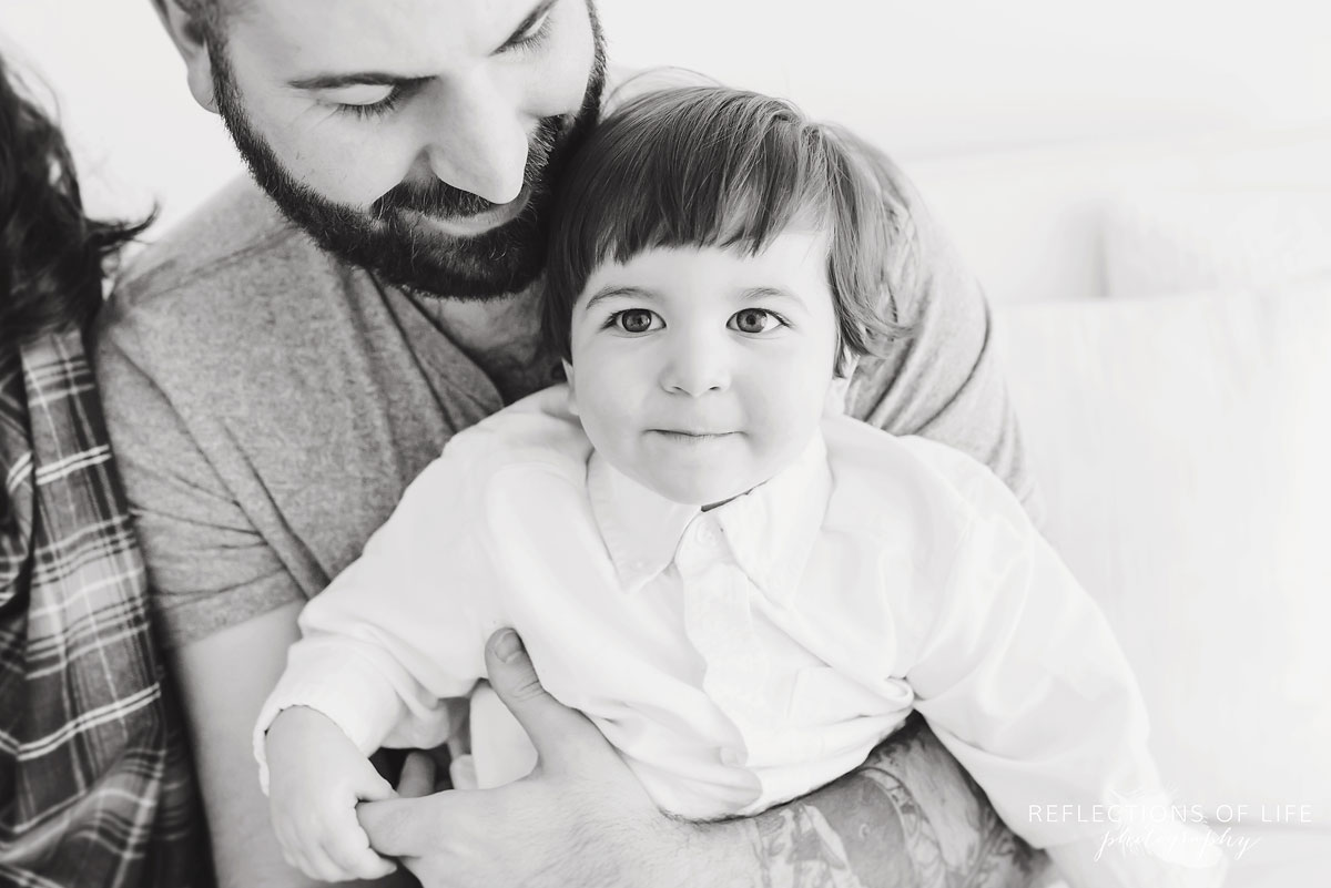 Father holding son black and white