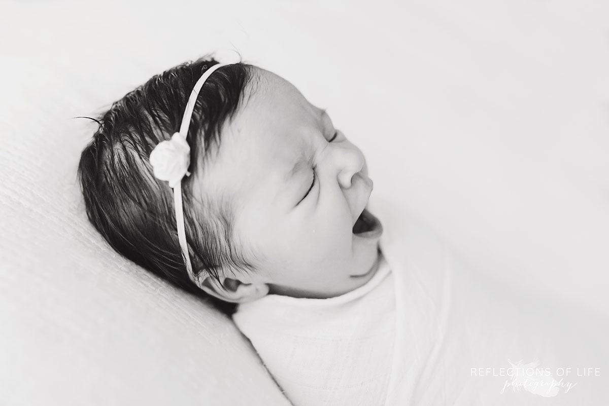 little newborn baby girl yawning.jpg
