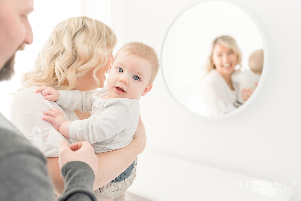 Copy of Copy of little boy having fun playing by a mirror in Niagara Ontario