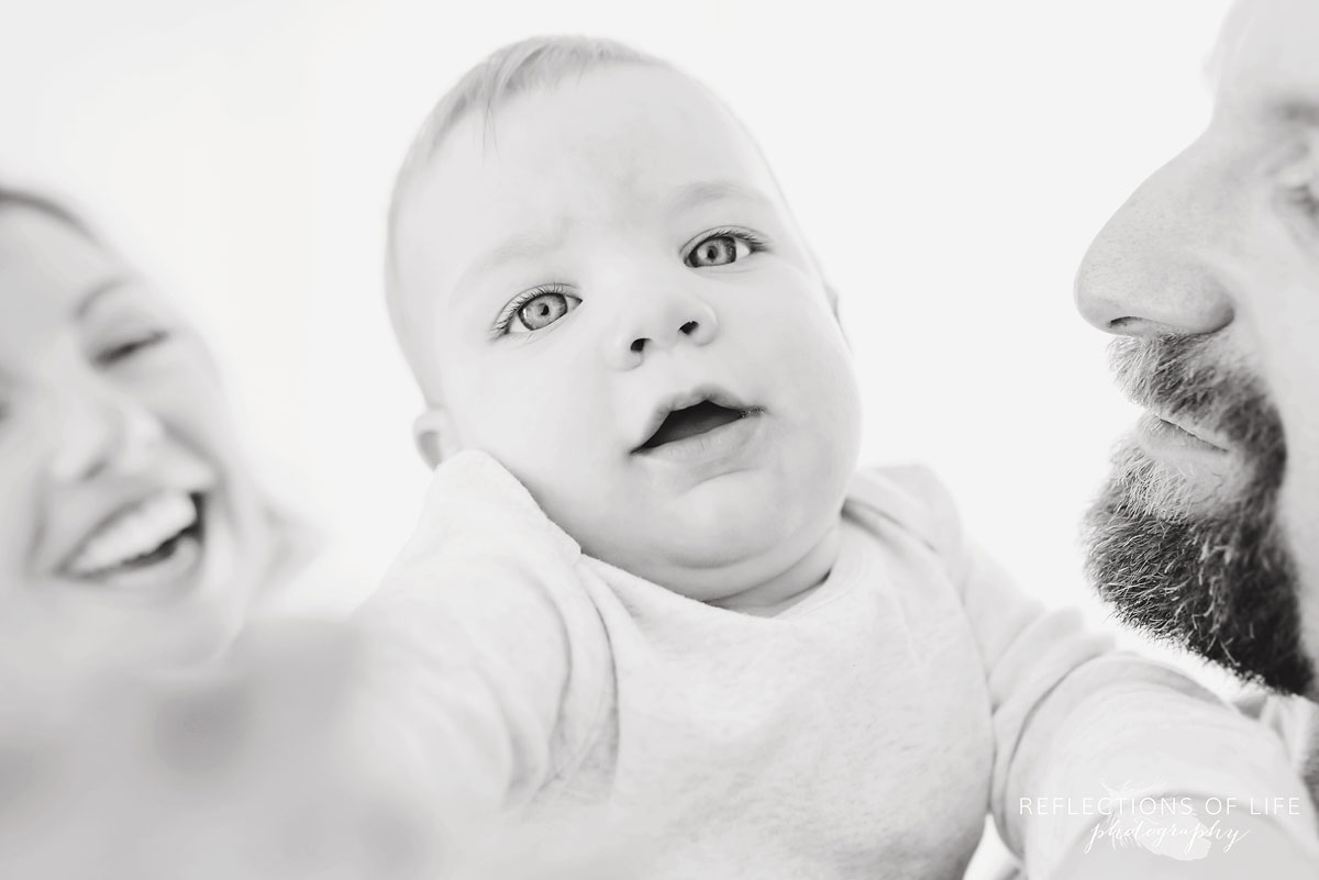 Copy of Copy of  baby boy trying to grab the camera in black and white