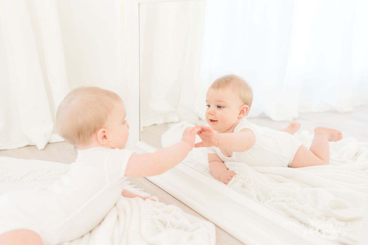 Copy of Copy of little baby boy looking at himself in the mirror