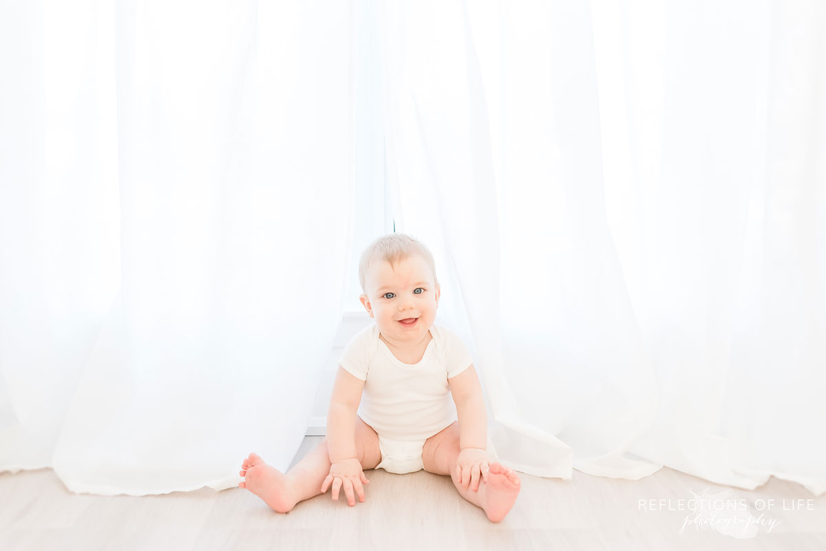Copy of Copy of Baby boy sitting in the white curtains