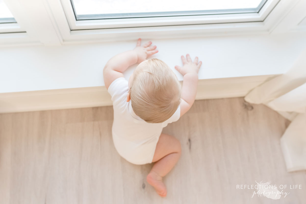 Copy of Copy of Baby boy looking out the window birds eye view