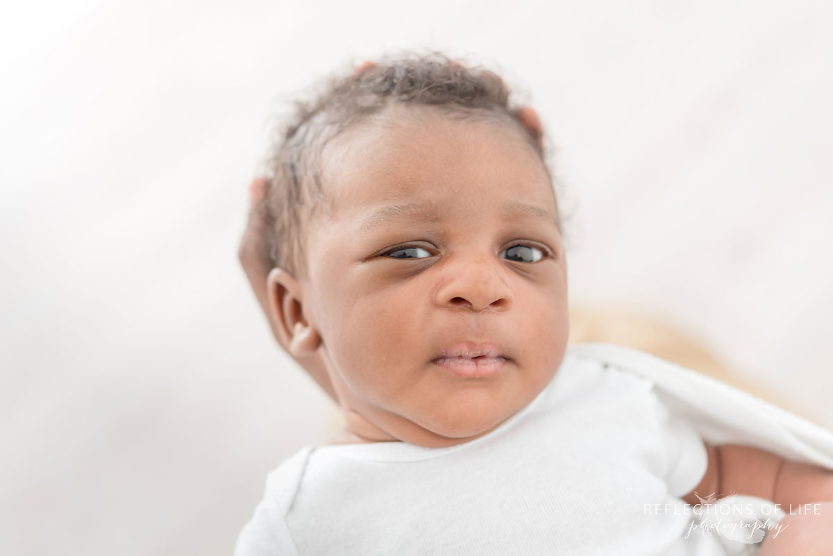 adorable newborn baby boy in white studio niagara ontario