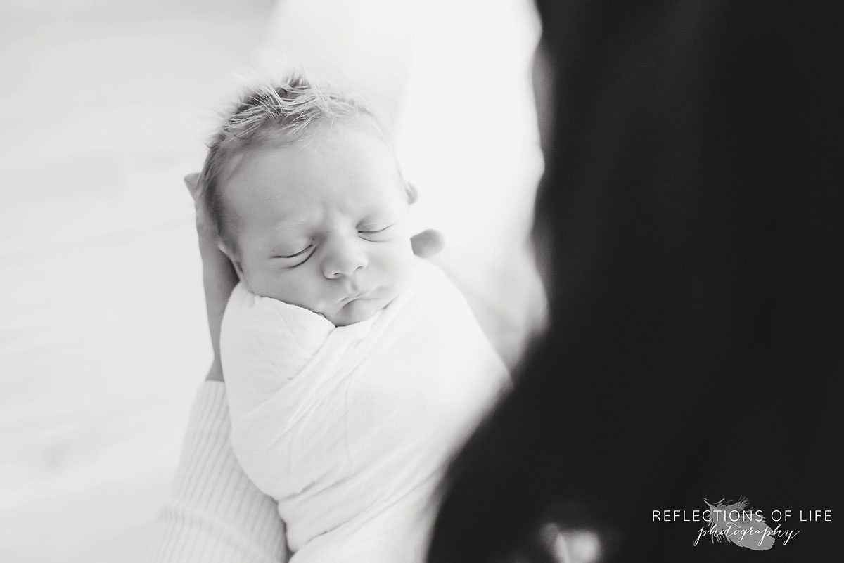 Little newborn baby boy sleeping in his mamas arms.jpg