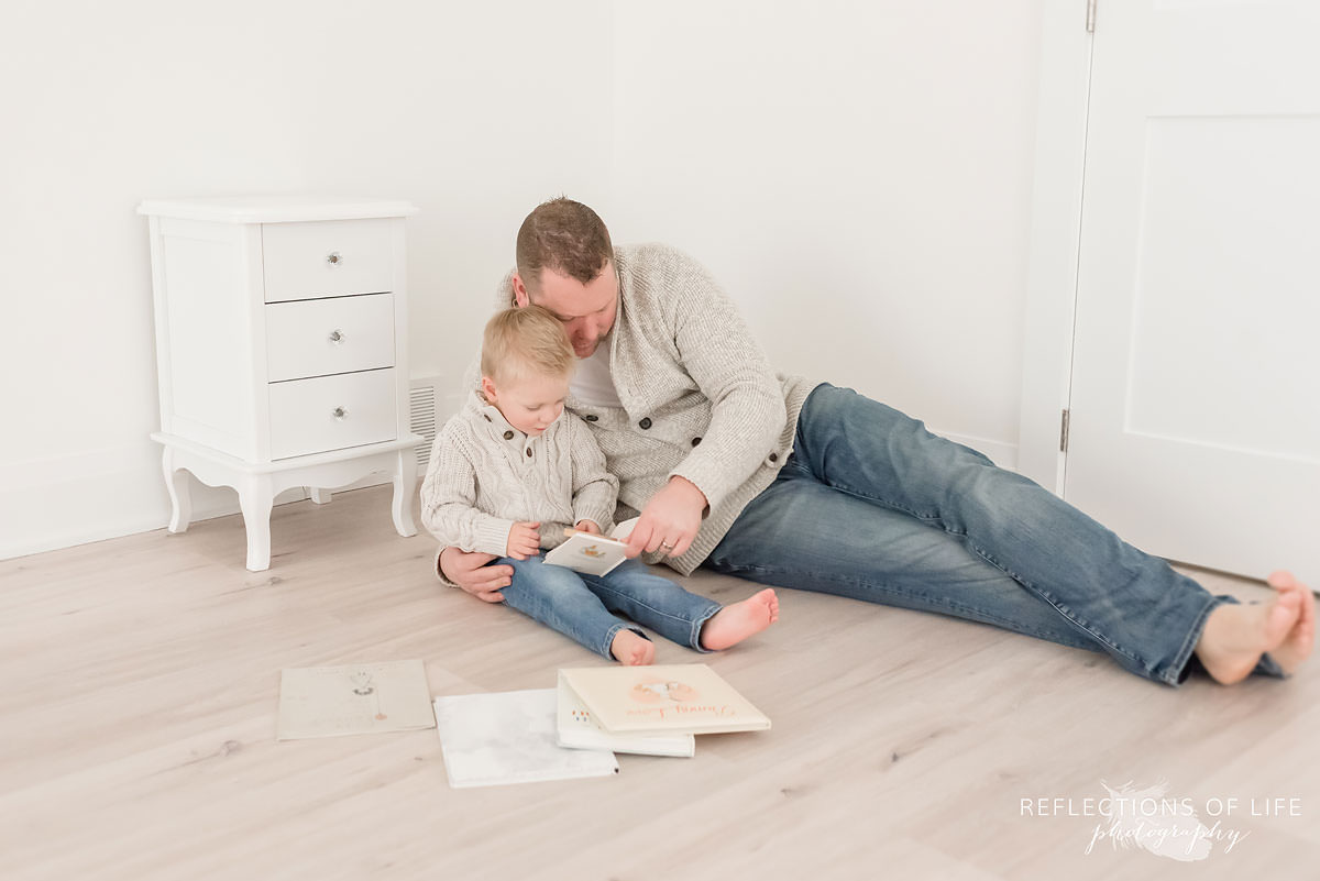 Dad and his son reading a book in natural light photo studio.jpg