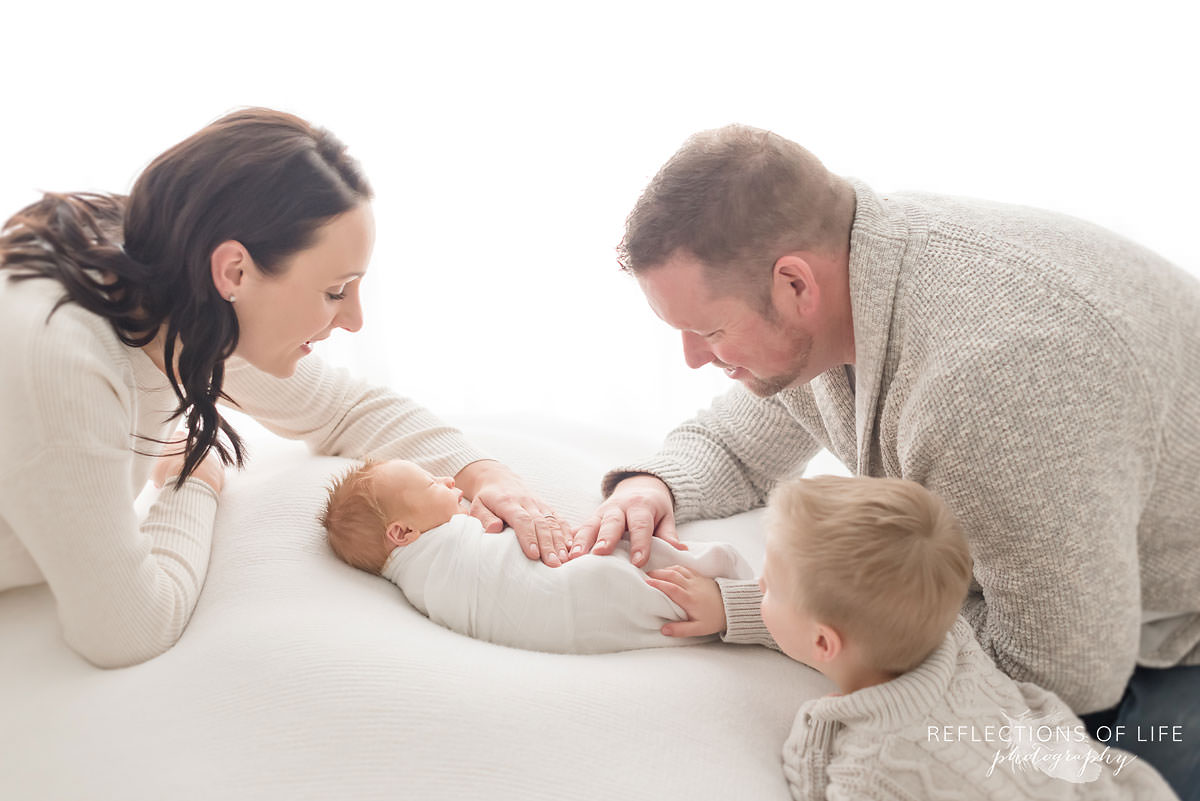 family photograph of little boy and newborn with parents.jpg
